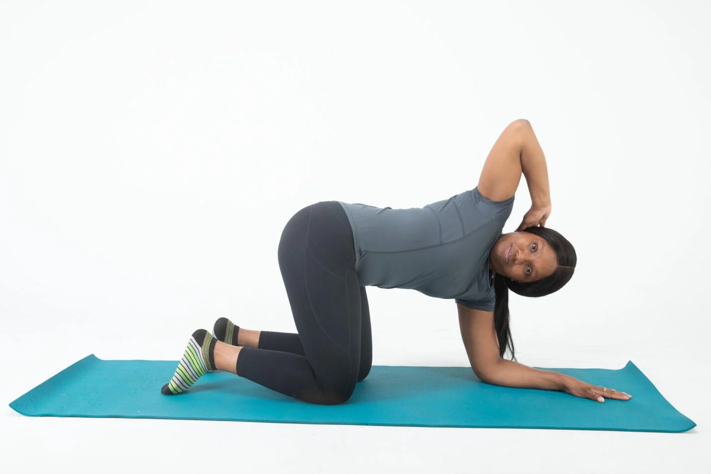 Demonstration of a stretching exercise on a yoga mat demonstration of a stretching exercise on a yoga mat